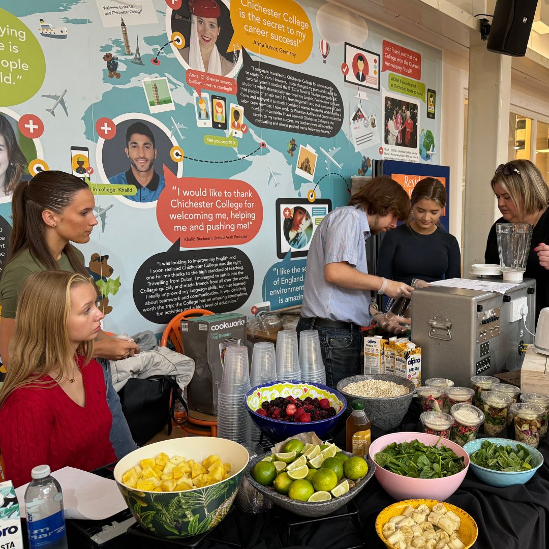 Chichester College business students pictured in front of smoothie stall