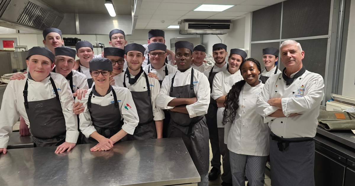 Catering and Hospitality students stood in kitchen with their lecturer