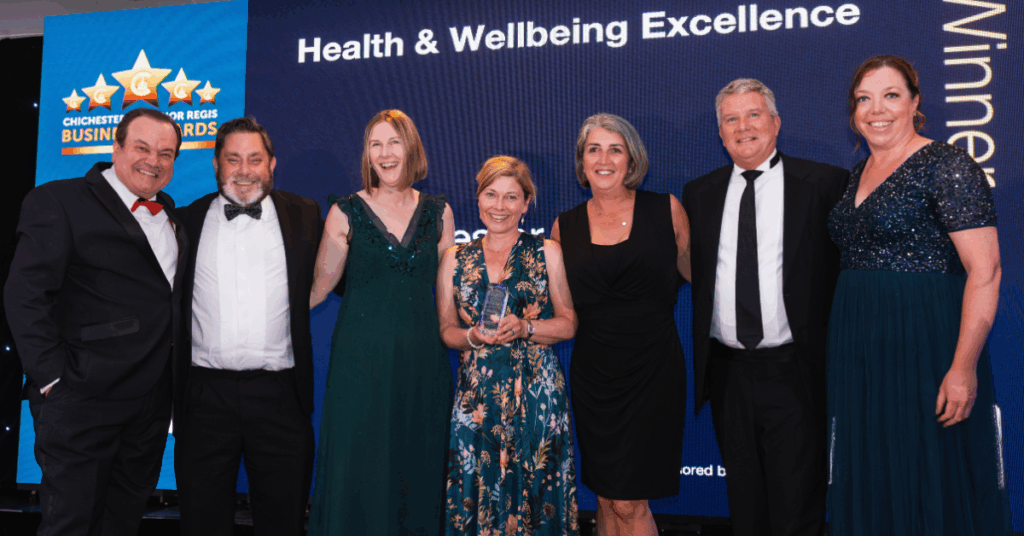 Some of the College staff up on stage receiving the Health & Wellbeing Excellence