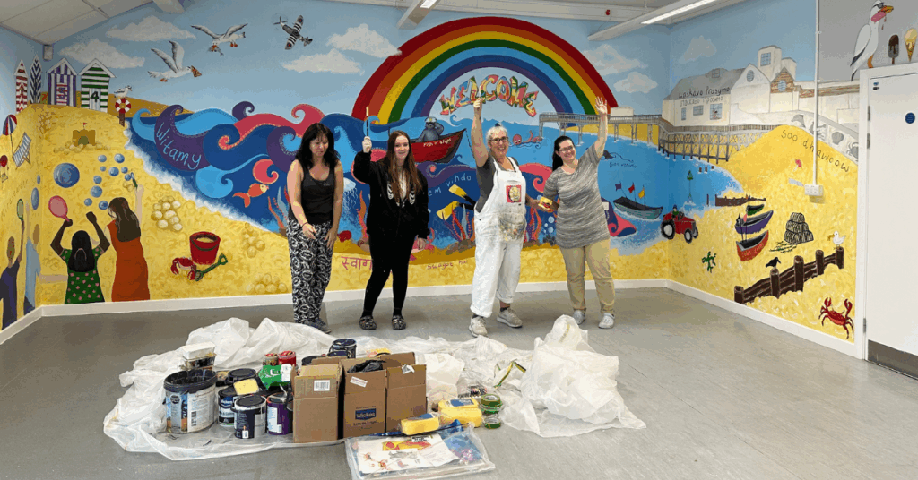 Some of the college's Art and Design students stood by the mural