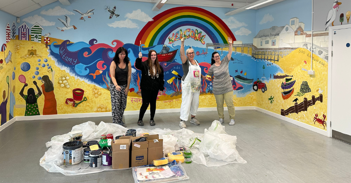 Some of the college's Art and Design students stood by the mural