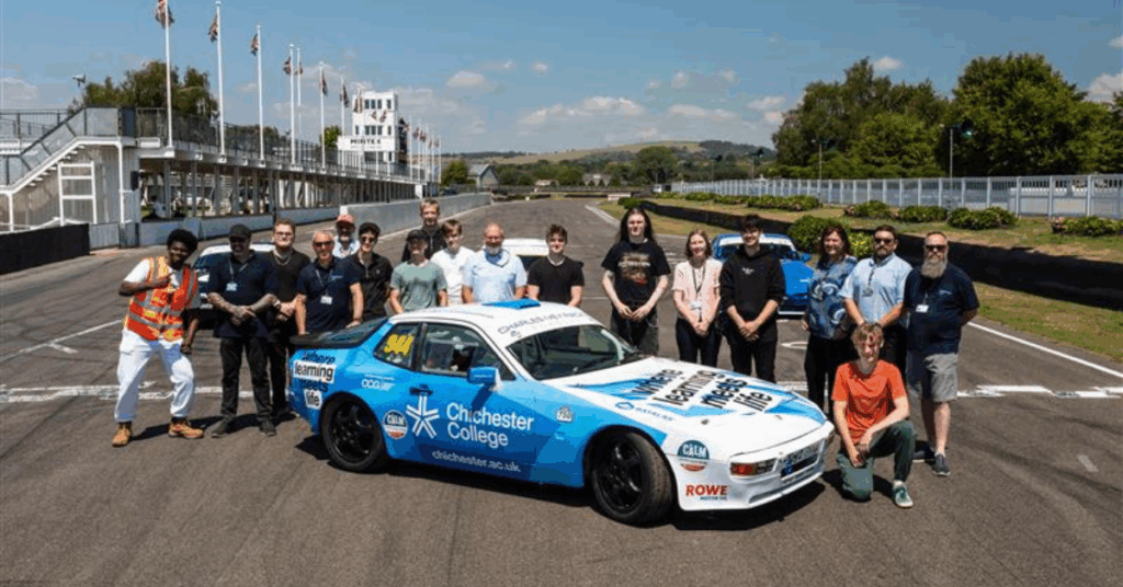 A group of all the stakeholders involved, stood around the new car