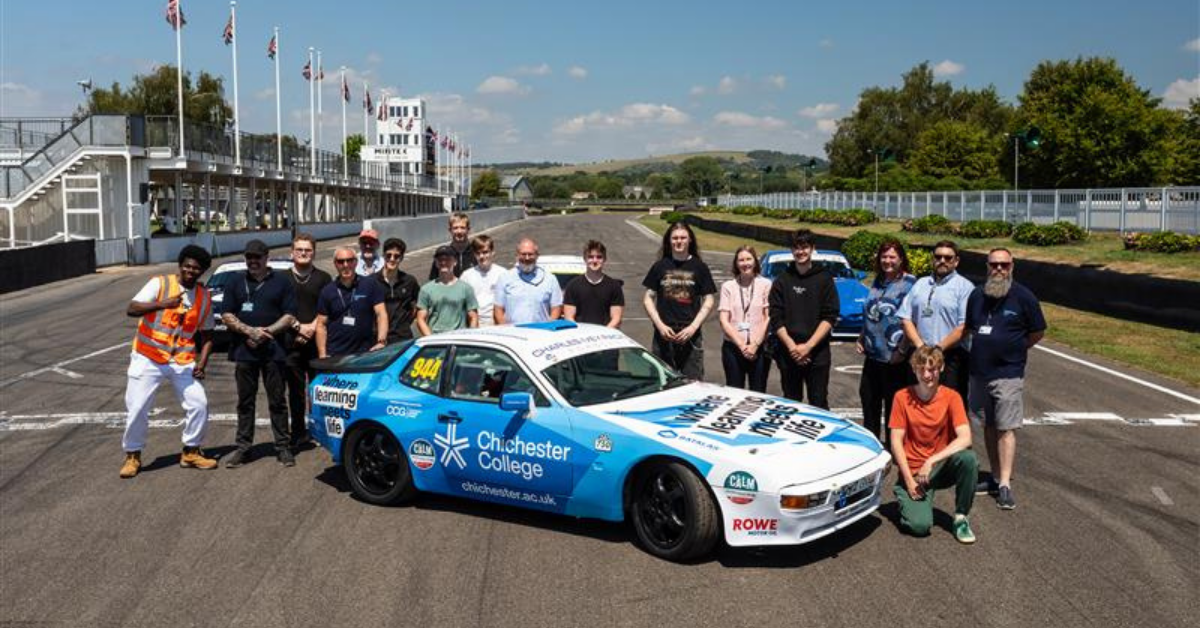 A group of all the stakeholders involved, stood around the new car