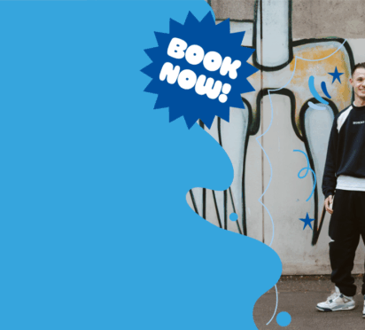 Image of a smiling student standing in front of graffiti wall promoting Chichester College Open Events.