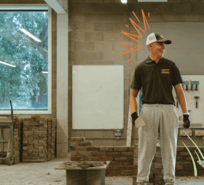 Bricklaying student standing in a workshop