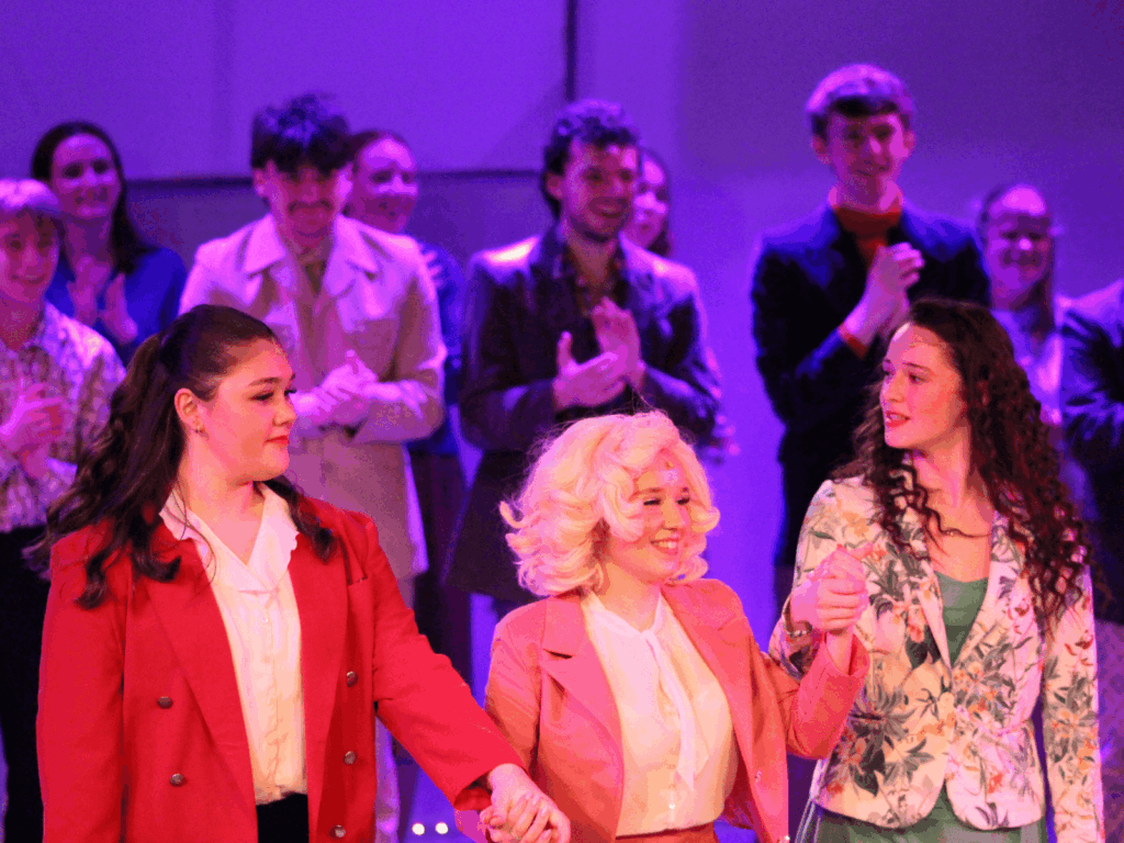 Our students raising hands as they take the audience's applause at the end of the show