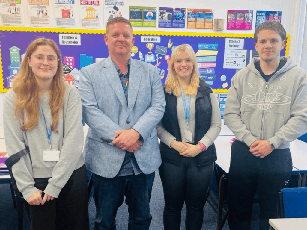 2 students from the programme stood with Brad Ainsworth