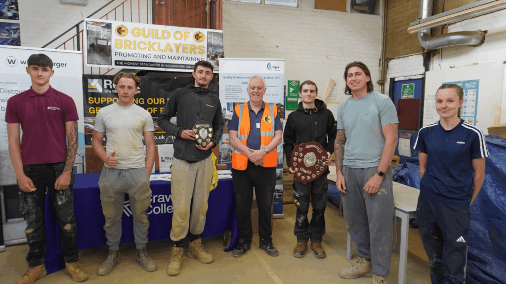 The top 3 students from each category stood with the Guild of Bricklayers organisers
